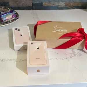 Christian Louboutin and two Apple phone boxes